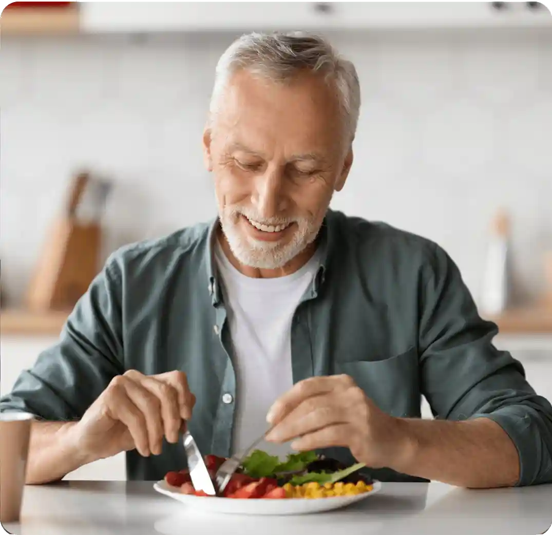 Older man eating salad