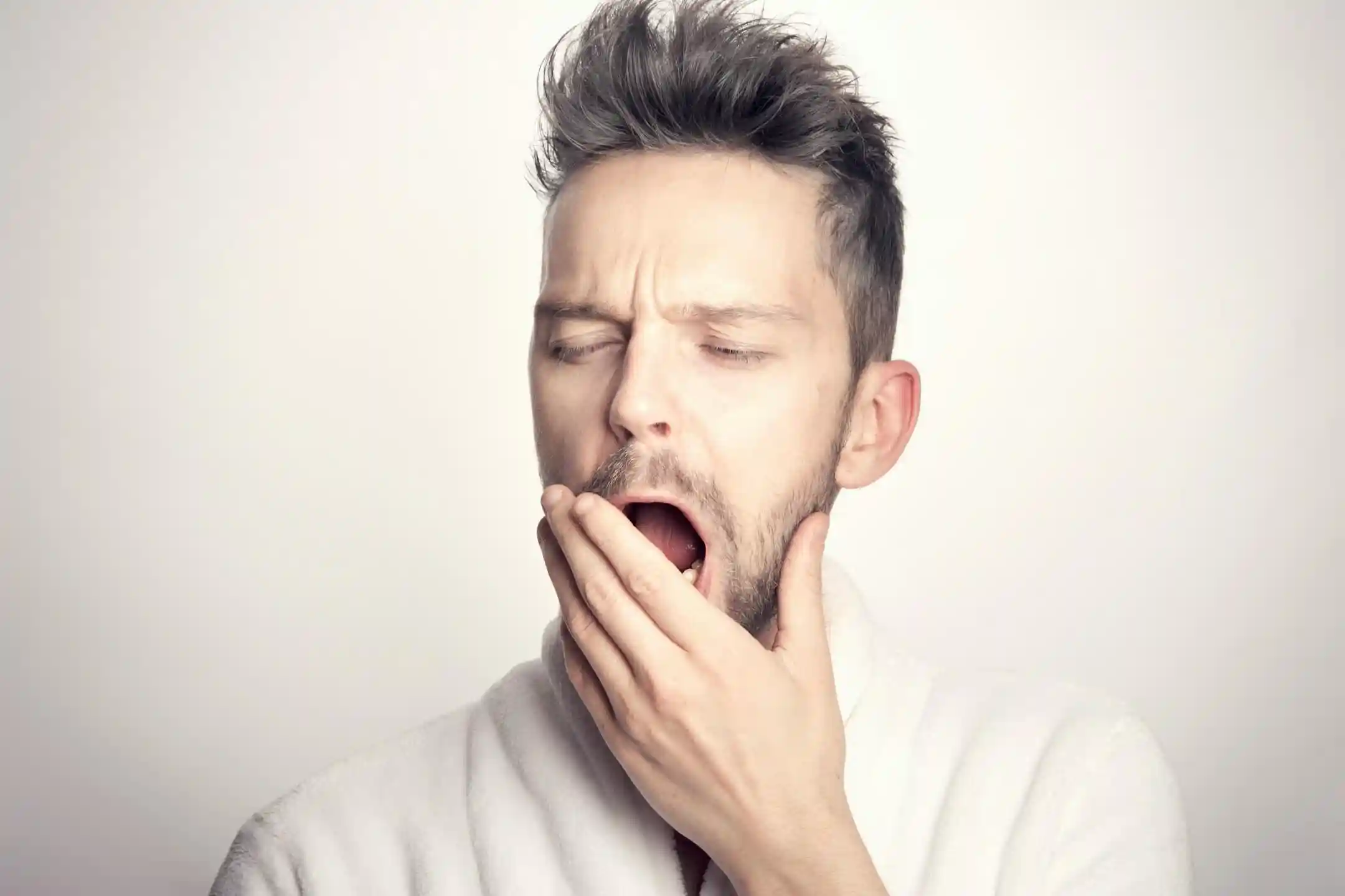 Tired man yawning